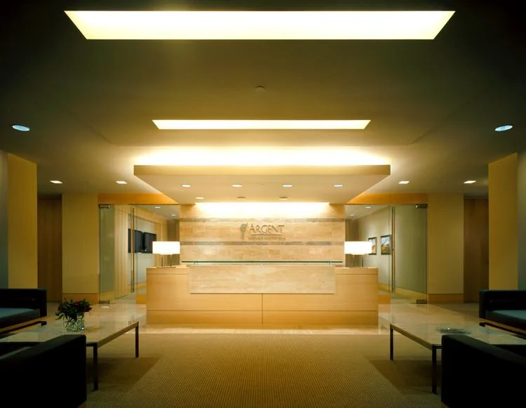 Symmetrical reception with light timber and stone finishes.
