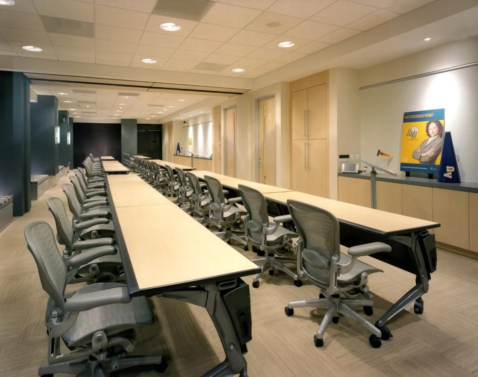 Large training room with rows of tables and chairs.