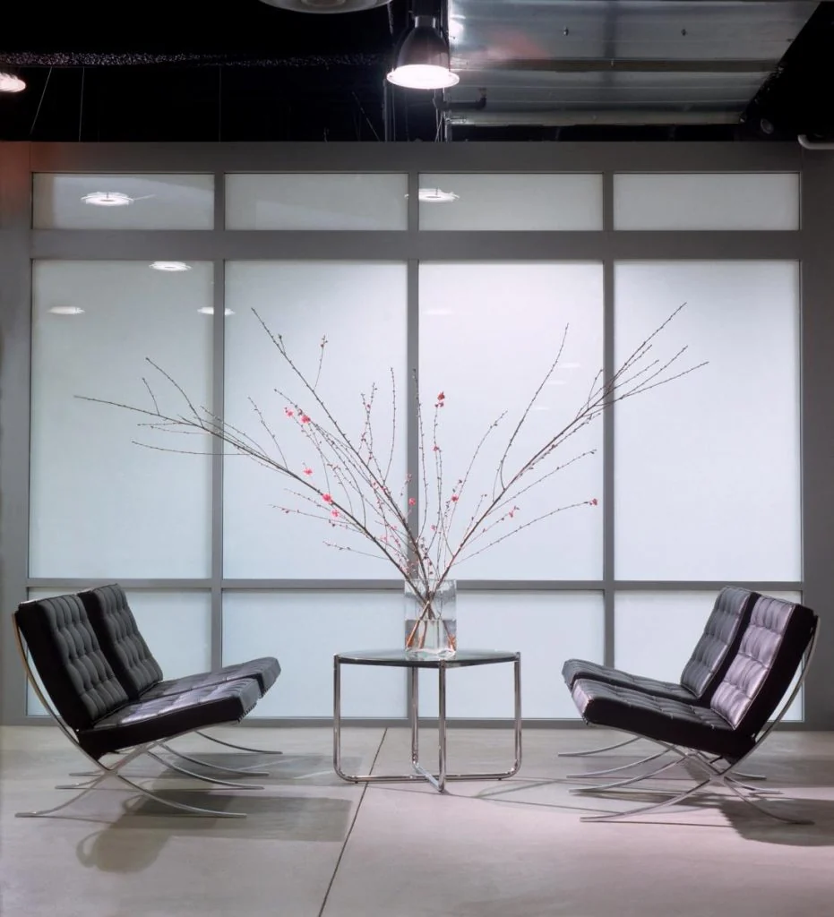 Workplace lounge with two leather chairs.