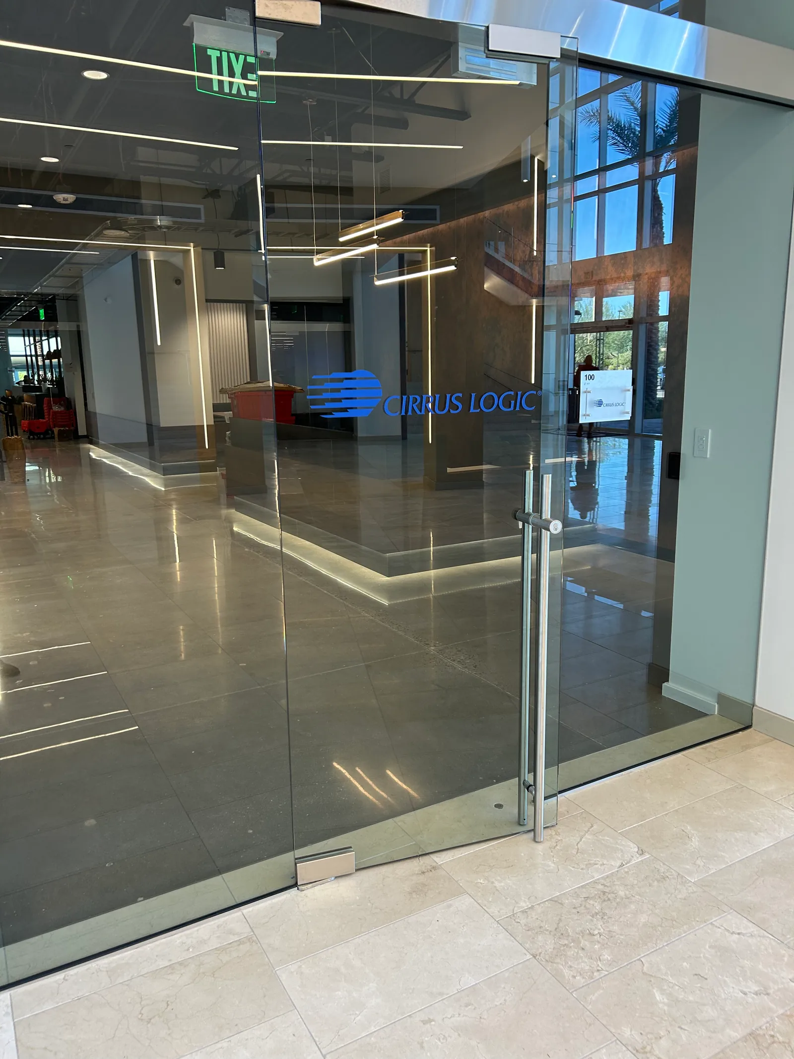 Glass entry doors with Cirrus Logic branding.