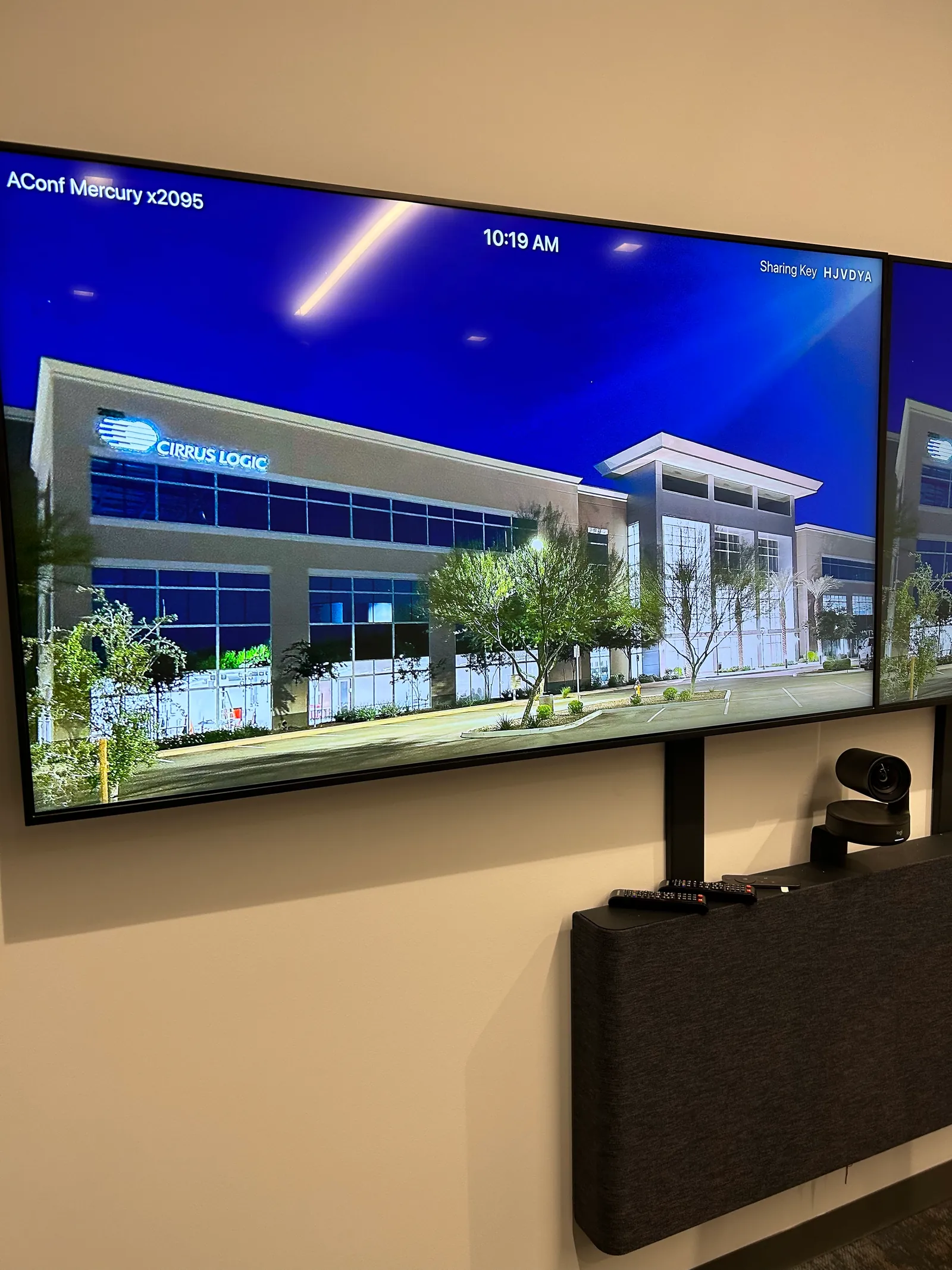 Wall-mounted display showing an exterior image with Cirrus Logic branding.