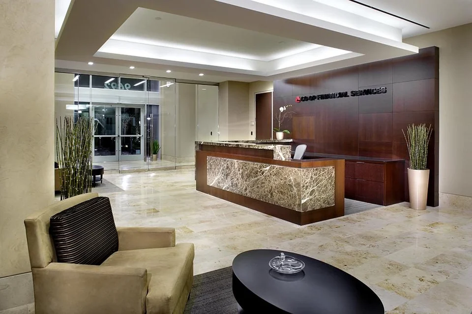 Reception with timber surfaces and a stone counter.