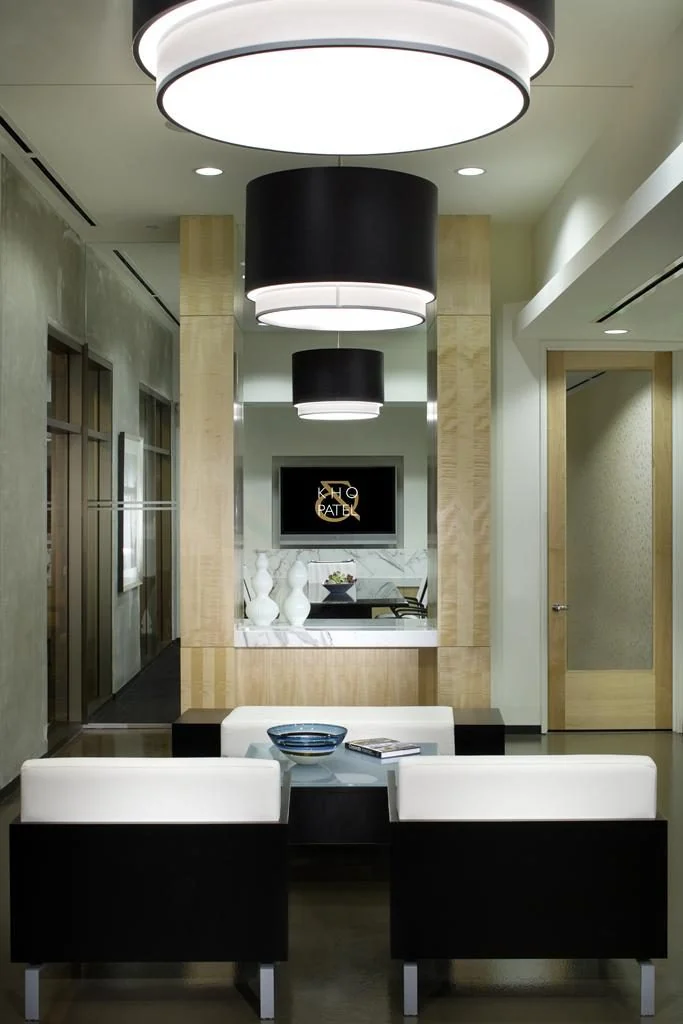 Reception desk framed by a long interior axis.