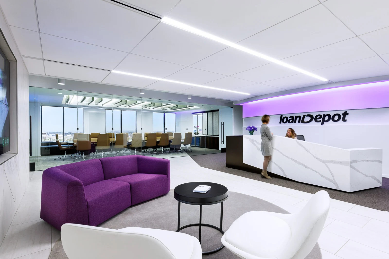 Reception area with a curved purple sofa.