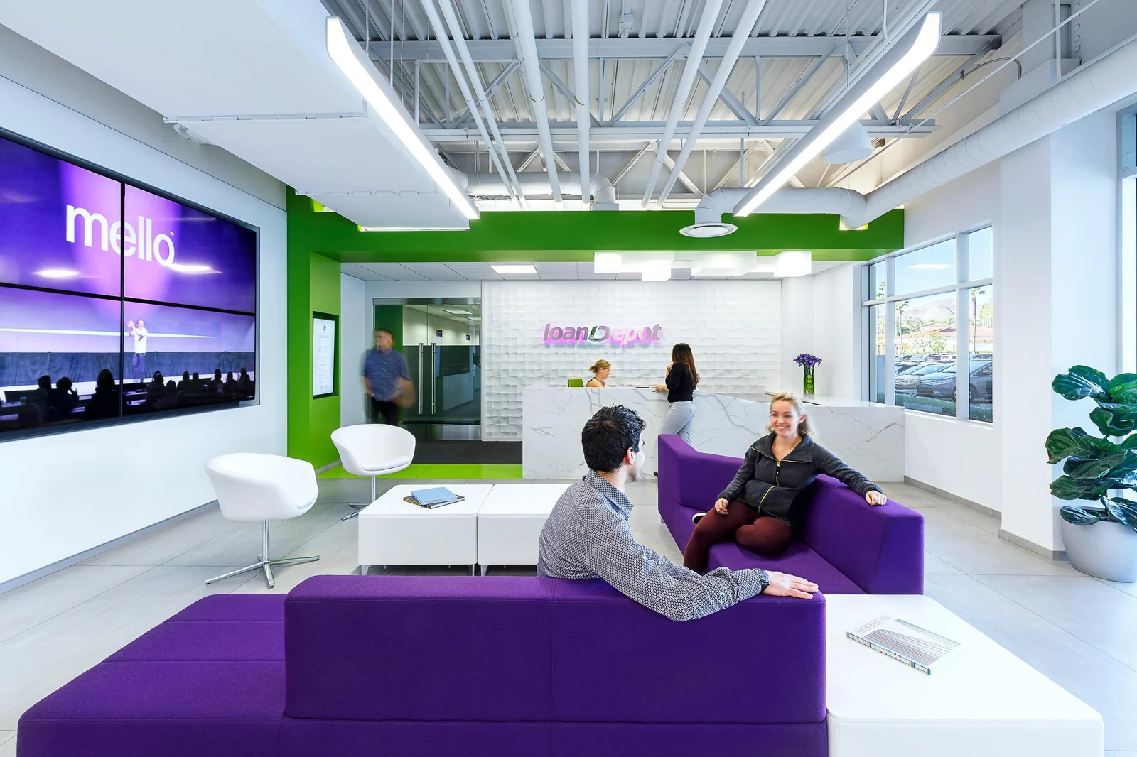 Welcome lounge with purple seating and a reception desk.