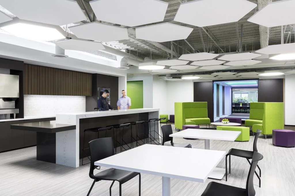 Café seating beneath a suspended geometric ceiling.