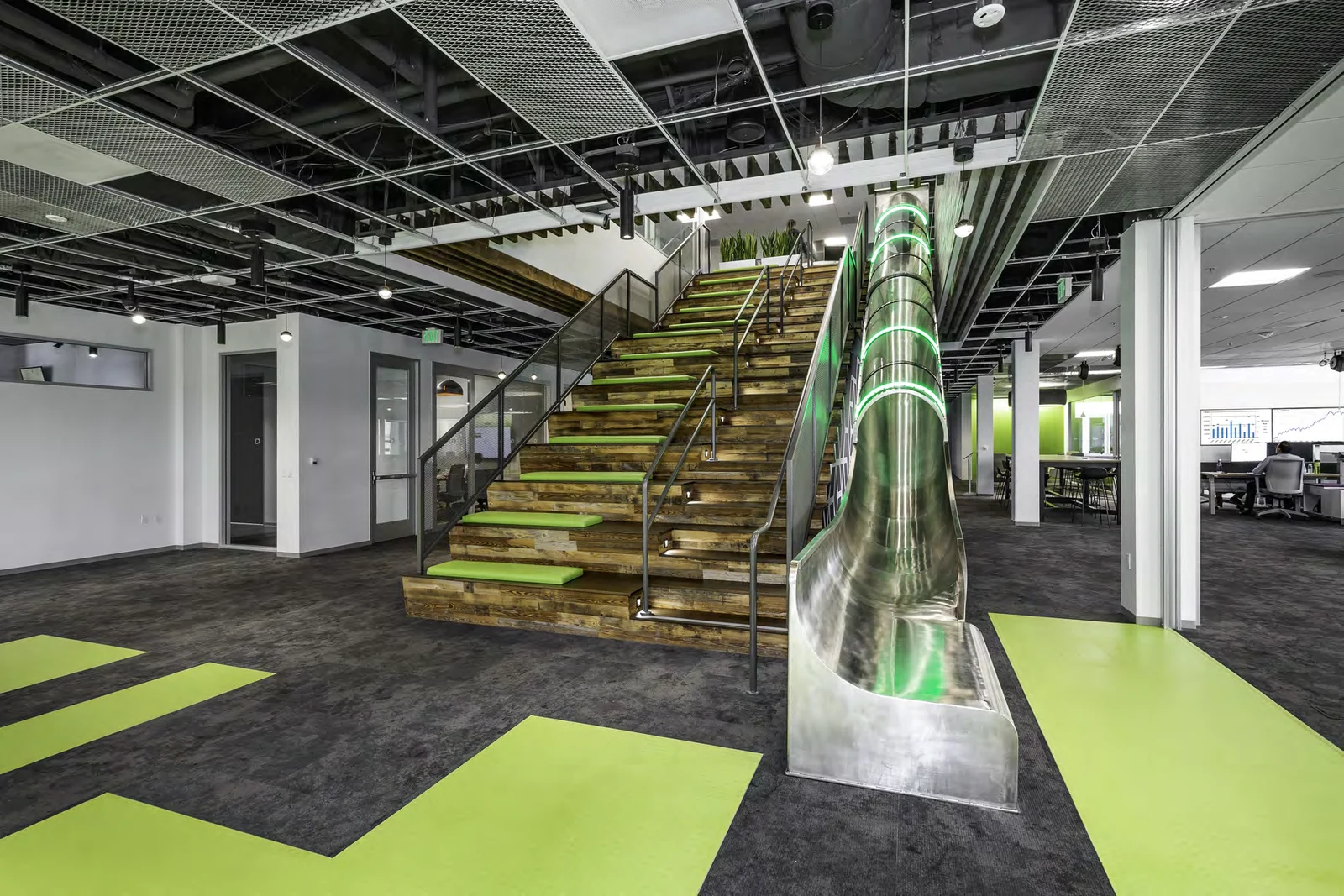 Timber staircase beside an indoor slide.