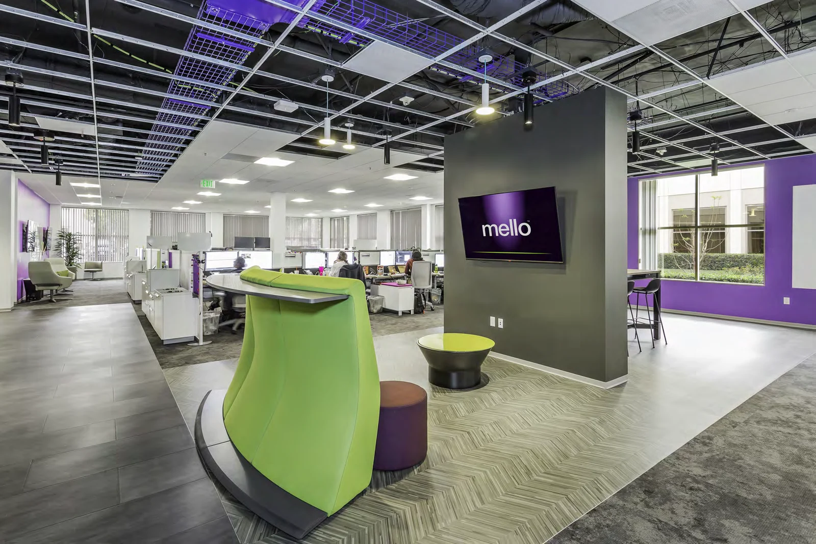 High-backed green seating creates a small meeting space.