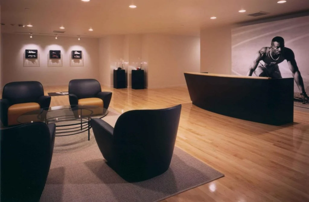 Nike reception with a dark counter and warm timber surfaces.