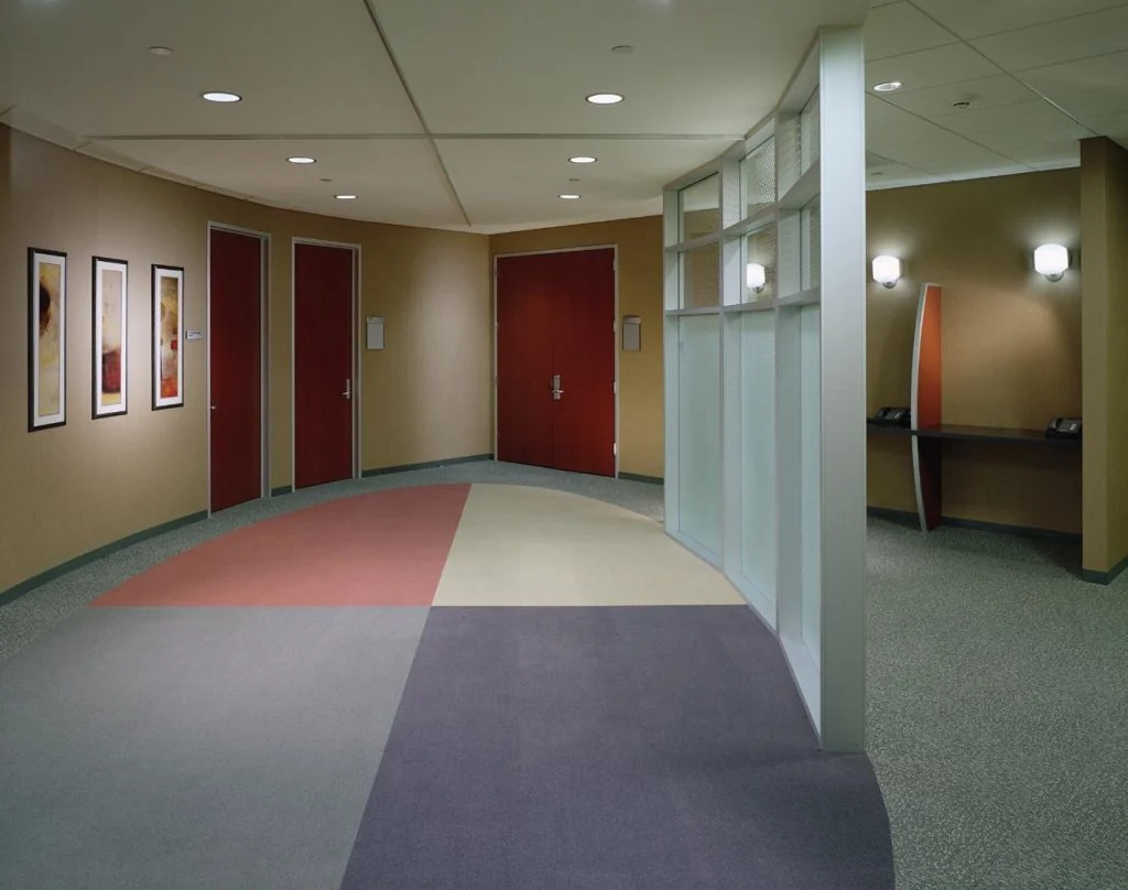 Interior corridor beside a curved partition.